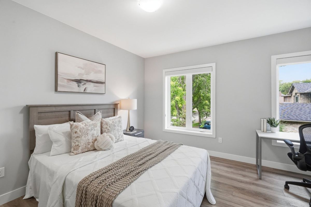 Bright bedroom with large windows and work space